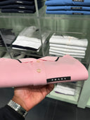 Polo en piqué de coton rose pâle à finitions contrastées