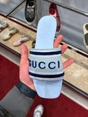 Mules plates logo brodé bleu ciel et bleu marine