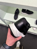 Sneakers en cuir et nylon noir à semelle oversize contrastante