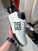 Sneakers épaisses en cuir blanc à monogramme contrastant