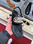 Sandales plates Horsebit en cuir noir et toile tressée