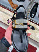 Sandales plates Horsebit en cuir noir et toile tressée